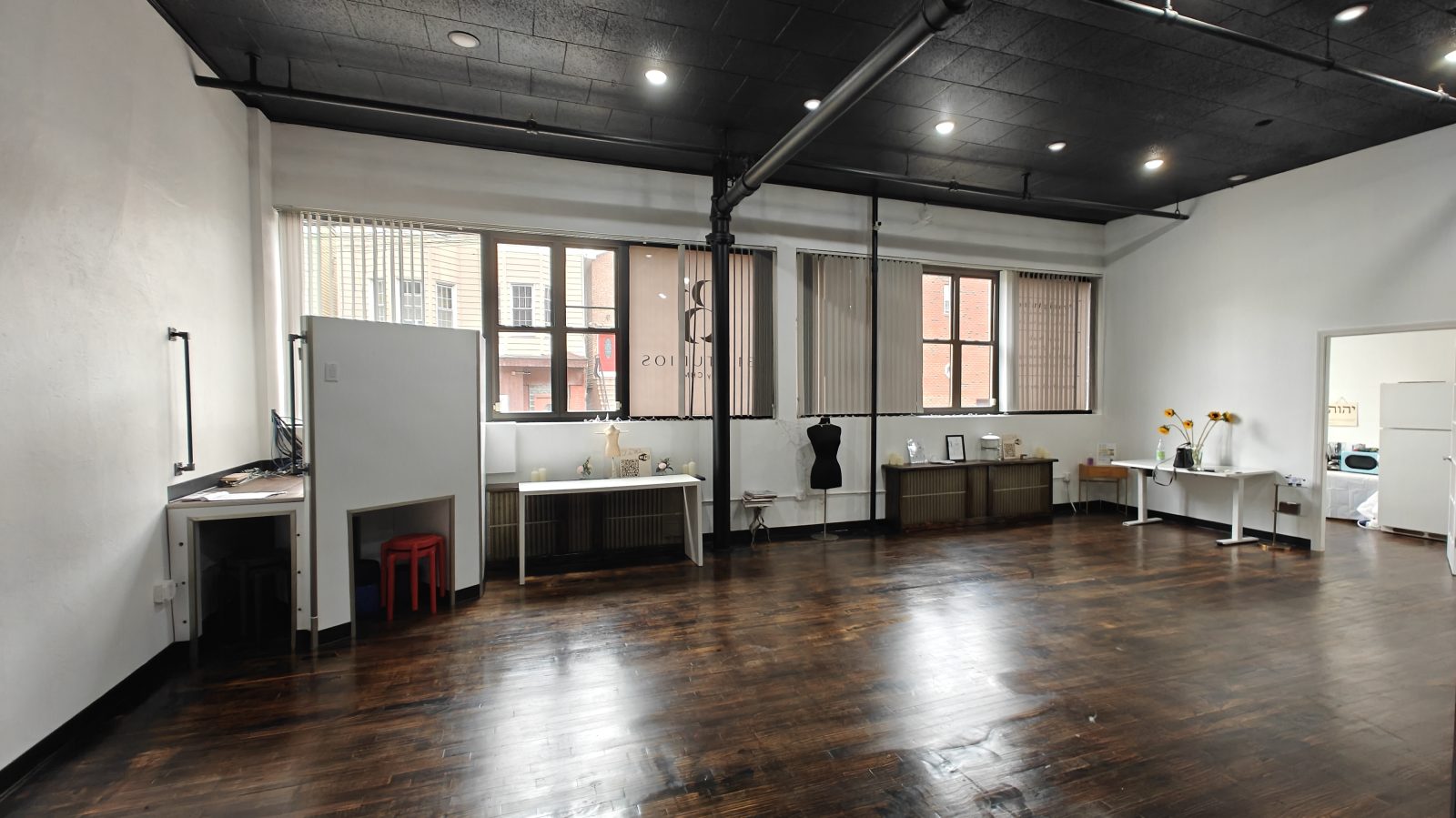 Street windows and work tables along the wall